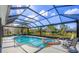 Inviting screened pool and spa offering picturesque waterfront views, perfect for relaxation and entertaining at 4 Saint Martin Cir, Englewood, FL 34223