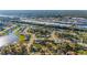 Aerial photograph of the community with river access, many homes, a lake, and nearby businesses at 4383 Mckibben Dr, North Port, FL 34287