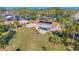 Aerial view of a well-maintained home featuring a screened-in porch, solar panels, a shed, and a spacious backyard at 4383 Mckibben Dr, North Port, FL 34287