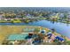 Aerial view of the community park showing the tennis courts, basketball court, playground, and lake access at 4383 Mckibben Dr, North Port, FL 34287