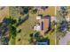 Aerial view of the property showcasing a well-maintained lawn, solar panels, screened in porch, and a convenient storage shed at 4383 Mckibben Dr, North Port, FL 34287