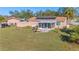 Lovely backyard featuring a screened-in porch, solar panels, outdoor seating, a storage shed, and a lush lawn at 4383 Mckibben Dr, North Port, FL 34287