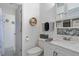 Well-lit bathroom with stylish vanity, decor and shower with coastal themed curtain at 4383 Mckibben Dr, North Port, FL 34287