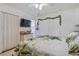 Bright bedroom with leafy bedding and mounted TV at 4383 Mckibben Dr, North Port, FL 34287