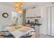 Bright dining room features white cabinets, coffee bar, woven pendant lights, and dining table at 4383 Mckibben Dr, North Port, FL 34287