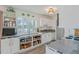 Bright kitchen featuring white cabinets, granite countertops, open storage, and a window for natural light at 4383 Mckibben Dr, North Port, FL 34287