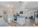 Bright kitchen featuring white cabinets and granite countertops, open to a bedroom and entryway at 4383 Mckibben Dr, North Port, FL 34287