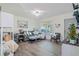 Comfortable living room showcasing a plush gray sofa, coastal decor, and natural light from a bright window at 4383 Mckibben Dr, North Port, FL 34287