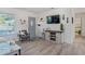 Inviting entryway featuring light wood flooring, a modern gray chair, and stylish coastal decor at 4383 Mckibben Dr, North Port, FL 34287