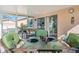 Screened patio with tiled floor, furnished with a variety of outdoor furniture at 4383 Mckibben Dr, North Port, FL 34287