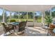 Screened patio with tile flooring, outdoor furniture, and a view of the backyard at 4383 Mckibben Dr, North Port, FL 34287