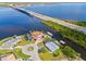 Panoramic aerial perspective displaying the house, waterfront, boat docks, bridge, and vibrant surroundings at 5196 Early Ter, Port Charlotte, FL 33981