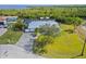 Expansive aerial view of the house with lush lawn, long driveway, screened in pool, and waterway access at 5196 Early Ter, Port Charlotte, FL 33981