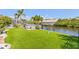 Waterfront backyard featuring artificial turf and boat lift at 5196 Early Ter, Port Charlotte, FL 33981