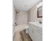 Clean bathroom featuring a shower-tub combo with tiled walls, stylish vanity, and neutral color palette at 5196 Early Ter, Port Charlotte, FL 33981