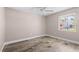 Empty bedroom with wood-look flooring, ceiling fan, and natural light at 5196 Early Ter, Port Charlotte, FL 33981