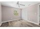 Bedroom features wood-look flooring, ceiling fan, and natural light at 5196 Early Ter, Port Charlotte, FL 33981