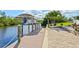 Waterfront dock features pavers, a covered boat lift, and professional landscaping at 5196 Early Ter, Port Charlotte, FL 33981