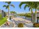 Backyard dock area has a covered boat lift, landscaping and a view of the canal at 5196 Early Ter, Port Charlotte, FL 33981