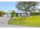 Well-maintained single-story home with lush front lawn and mature tree in a residential neighborhood at 5196 Early Ter, Port Charlotte, FL 33981