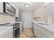 Modern kitchen featuring stainless steel appliances, light colored cabinets, and sleek countertops at 5196 Early Ter, Port Charlotte, FL 33981