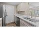 Bright kitchen featuring stainless appliances, a double basin sink, and a breakfast bar at 5196 Early Ter, Port Charlotte, FL 33981