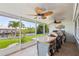 Open-air lanai with outdoor kitchen, ceiling fans, and water views provides a serene entertaining space at 5196 Early Ter, Port Charlotte, FL 33981