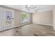 Bright living room featuring wood-look flooring, ceiling fans, and a decorative glass door at 5196 Early Ter, Port Charlotte, FL 33981