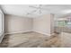 Bright living room featuring wood-look flooring, neutral paint, ceiling fans, and natural light at 5196 Early Ter, Port Charlotte, FL 33981