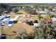 Aerial view of charming yellow single Gathering home in a quiet neighborhood with beautiful green trees at 8029 Roy Dr, Punta Gorda, FL 33982