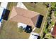 Aerial view of the roof of a charming yellow single Gathering home in a quiet neighborhood with beautiful green trees at 8029 Roy Dr, Punta Gorda, FL 33982