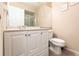 Bathroom displaying a white vanity, toilet and a large mirror at 8029 Roy Dr, Punta Gorda, FL 33982