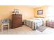 Bright bedroom featuring a comfortable bed, dresser, and neutral tones at 8029 Roy Dr, Punta Gorda, FL 33982