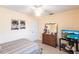 Bedroom showcasing a bed, dresser with mirror, and a modern TV set up at 8029 Roy Dr, Punta Gorda, FL 33982