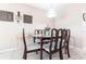 Traditional dining room with dark wood table and chairs and decorative wall art at 8029 Roy Dr, Punta Gorda, FL 33982