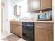 Functional kitchen featuring dark brown cabinets, tile flooring, and modern appliances at 8029 Roy Dr, Punta Gorda, FL 33982