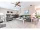 Inviting living room featuring tile flooring, comfortable seating, a ceiling fan and view into dining area at 8029 Roy Dr, Punta Gorda, FL 33982