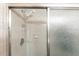 Shower area with textured glass door, handheld showerhead and soap caddy at 8029 Roy Dr, Punta Gorda, FL 33982