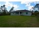 Enjoy outdoor living in this backyard with a spacious lawn and room to relax at 8226 Olsen St, Port Charlotte, FL 33981