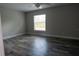 Bright bedroom with wood-look floors and a large window, creating a comfortable and inviting space at 8226 Olsen St, Port Charlotte, FL 33981