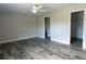 Spacious main bedroom features wood-look flooring, and ensuite bathroom and walk-in closet adding space and privacy at 8226 Olsen St, Port Charlotte, FL 33981