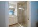 Bathroom with a glass-enclosed shower, white vanity, and marble accents at 8403 Placida Rd # 408, Placida, FL 33946