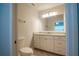 Bathroom featuring a sink with a white vanity, a large mirror, and a toilet at 8403 Placida Rd # 408, Placida, FL 33946