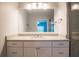 Modern bathroom boasts ample lighting, a sleek vanity, and marble-look shower at 8403 Placida Rd # 408, Placida, FL 33946