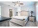 Bedroom featuring a large bed, plank floors, and ensuite bathroom at 8403 Placida Rd # 408, Placida, FL 33946