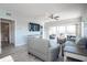 Bright living room with plank floors, modern furniture, and sliding doors to the screened balcony at 8403 Placida Rd # 408, Placida, FL 33946