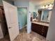 Stylish bathroom featuring tiled floors, vanity with granite countertops, and a toilet at 9175 Melody Cir, Port Charlotte, FL 33981