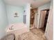 Well-appointed bathroom with a soaking tub and a separate tiled shower at 9175 Melody Cir, Port Charlotte, FL 33981