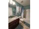 Well-lit bathroom featuring a shower-tub, a granite-topped vanity, and decorative accents at 9175 Melody Cir, Port Charlotte, FL 33981