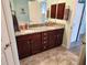 Bright bathroom with dual sinks, granite countertops, and wooden cabinets at 9175 Melody Cir, Port Charlotte, FL 33981